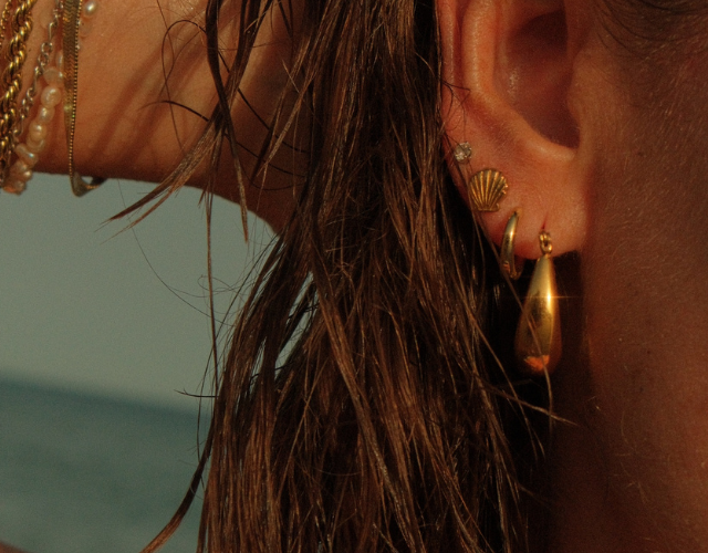 women's ear with waterproof gold earrings